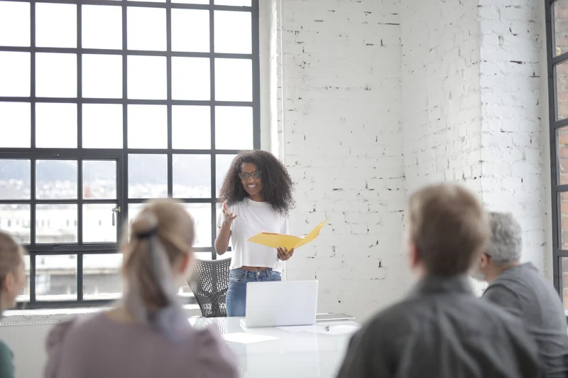 A presenter addresses a quiet, attentive meeting room